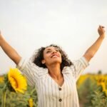 Photo Of Woman Standing On Sunflower Field