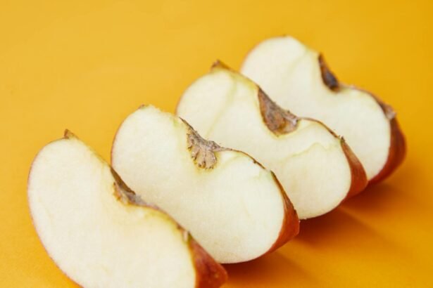 Fresh ripe pieces of apple placed in row on bright yellow background of studio