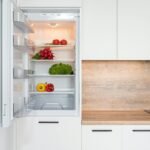 Fridge with different vegetable in modern kitchen