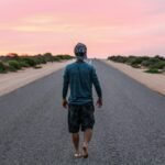 man walking on gray concrete road