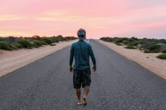 man walking on gray concrete road