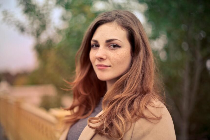 Closeup Photo of Woman With Brown Coat and Gray Top