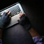 person in black long sleeve shirt using macbook pro